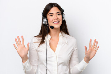 Telemarketer caucasian woman working with a headset isolated on white background counting ten with...