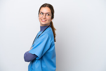 Young caucasian nurse woman isolated on white background with arms crossed and happy