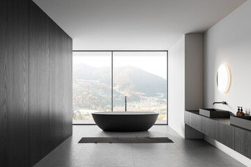 Modern minimalist bathroom interior with freestanding tub and panoramic mountain view, showcasing...