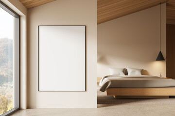 Minimalist bedroom interior with blank poster mockup on beige wall beside cozy bed under wooden...