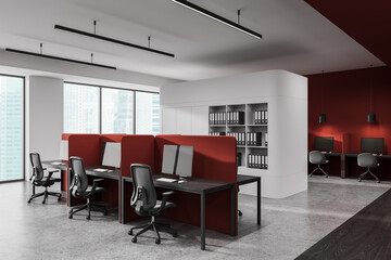 Modern open space office interior with red partitions, ergonomic chairs, and panoramic windows in a...