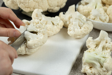 The Process of Slicing Raw Fresh Cauliflower.
