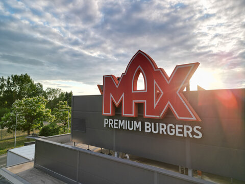 MAX Premium Burgers logo on building facade.