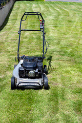 Lawn mower on green grass