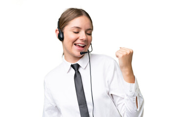 Telemarketer caucasian woman working with a headset over isolated background celebrating a victory