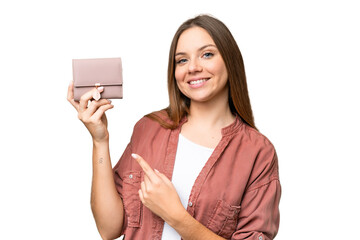 Young blonde woman holding a wallet over isolated chroma key background and pointing it