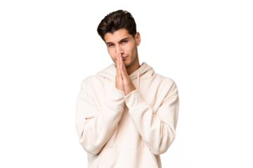 Young caucasian handsome man over isolated background keeps palm together. Person asks for something