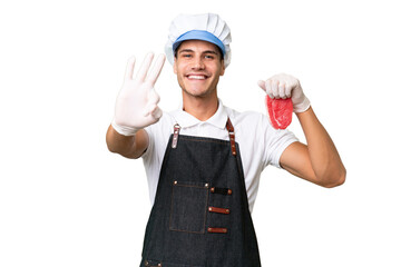 Butcher caucasian man wearing an apron and serving fresh cut meat over isolated background happy...