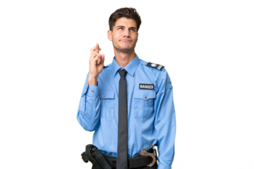 Young police man over isolated background with fingers crossing and wishing the best