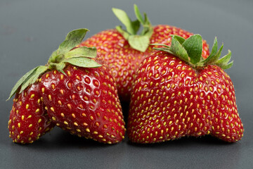 Fresh strawberries with an unusual shape close-up
