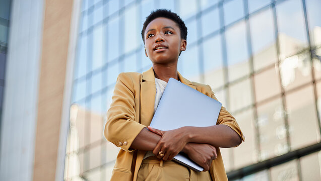 Confident Young Black Businesswoman Holding Laptop Standing Outside Modern Office Building