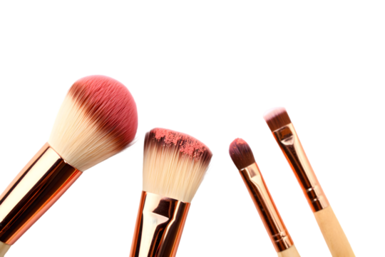 Rose Gold Makeup Brushes Set with Pink Blush Powder on Bristles Isolated on a transparent background