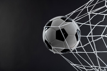 Soccer ball goal success on black background