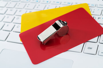 Football red and yellow cards on laptop keyboard