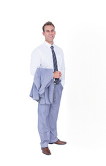 Man in business attire standing against white backdrop holding gray suit jacket and smiling