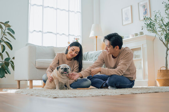 Asian family stay at home together with dog on holiday. Love couple lifestyle.