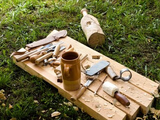 Handmade Wooden Bowl in Progress at Open-Air Workshop. Historical Woodcraft Scene with Primitive...
