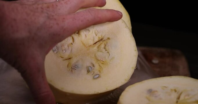 sliced squash with a hard peel, ripe white squash on the kitchen table during cooking and slicing