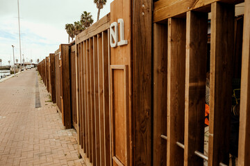 Wooden Marina Storage Units Along a Coastal Walkway