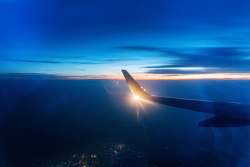 Wing at sunset through the window