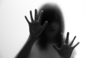 Silhouette of women behind frosted glass