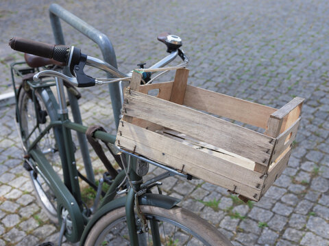 wooden Front basket on a luggage rack on a parked Utility bicycle