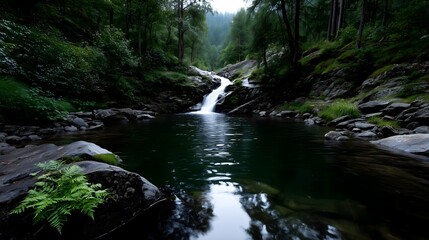 Serene waterfall flowing into tranquil pool surrounded by lush forest during early morning light
