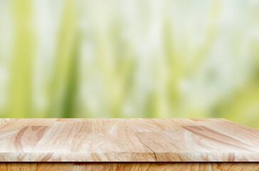 Empty wooden table with copy space on green nature background