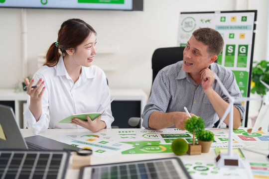 Sustainable business leaders discuss ESG strategies and carbon reduction goals in a modern office meeting