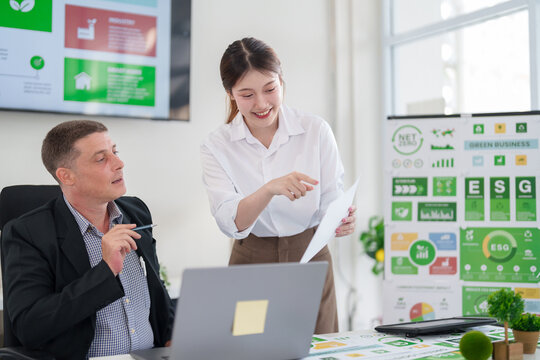 Business team collaborates on innovative ESG strategies for sustainable corporate growth and carbon footprint reduction in a modern office