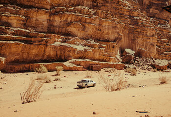 Off-Road Vehicle Driving Through Wadi Rum Desert Canyon