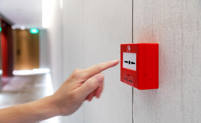 People hand pressing fire alarm