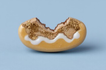 A surreal interpretation of technology and nature blending seamlessly in a half-eaten cookie revealing golden circuit patterns against a minimalist pastel blue backdrop capturing modern