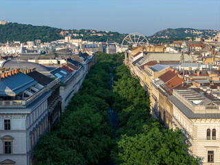 Andrassy street in Budapest, Hungary. Giant ferris wheel on the background