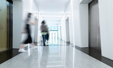 People walk in the elevator corridor