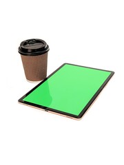 Tablet with blank green screen and paper coffee cup on white background.
