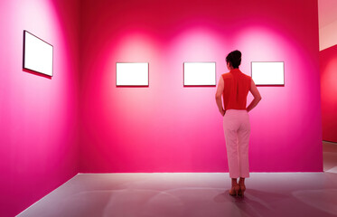 Woman standing and looking blank pictures