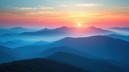 Colorful sunrise over a mountain range shrouded in mist.