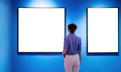 Woman standing and looking blank pictures