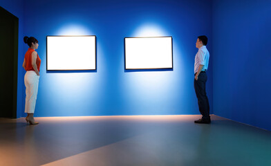 Fototapeta premium Businessman and businesswoman looking blank pictures