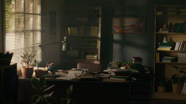No people shot of cluttered writers study with vintage typewriter and lots of books on dek by window