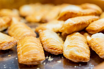 A scenic nighttime view of colorful round lanterns adorning the bridge piers above the water. The reflections shimmer on the calm surface, creating a magical and festive atmosphere that celebrates tra