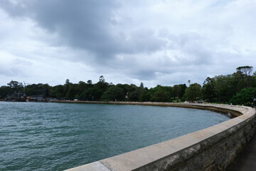 Farm Cove bay and Royal Botanic Gardens in Sydney, Australia observed during overcast cloudy sky in summer season.