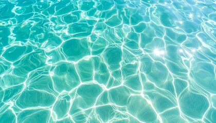 Obraz premium Clear turquoise water surface with bright sun caustics creating serene patterns