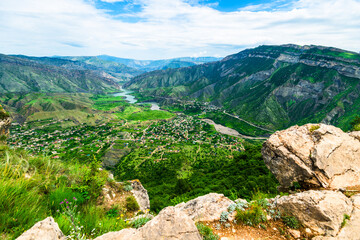Stunning mountain landscape of green mountain river valley with rock formations in foreground....