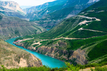 Picturesque landscape of Sulak Canyon with serpentine road and winding mountain river in the mountains of North Caucasus Dagestan. Russia