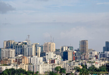 Obraz premium Dhaka city skyline with modern buildings and clear blue sky, urban architecture and cityscape view of Bangladesh capital. High angle view of Dhaka city residential and financial buildings at sunny day
