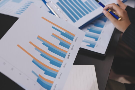 Team of business people working together in the meeting room office,
teamwork background charts and graphs banner, double exposure successful teamwork,business planning concept.
