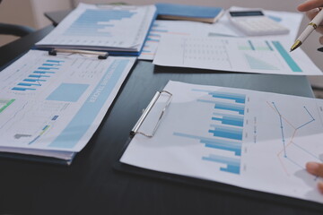 Obraz premium Team of business people working together in the meeting room office, teamwork background charts and graphs banner, double exposure successful teamwork,business planning concept.