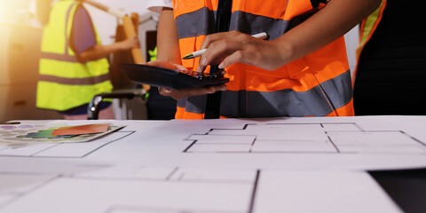 Closeup of team of industrial engineers meeting analyze machinery blueprints consult project on...